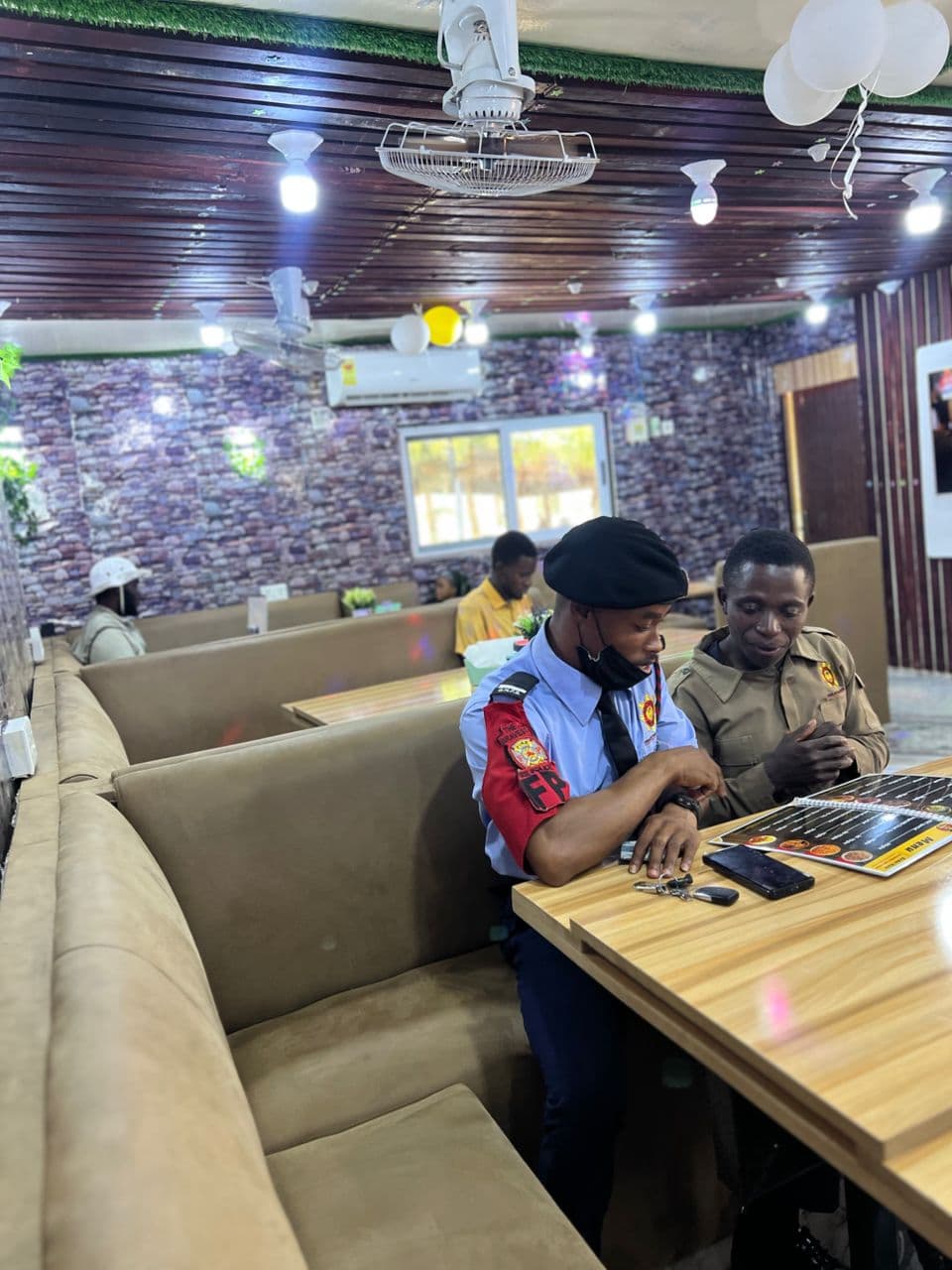 Guest browsing the menu inside Alkidoor Restaurant in a relaxed dining setting